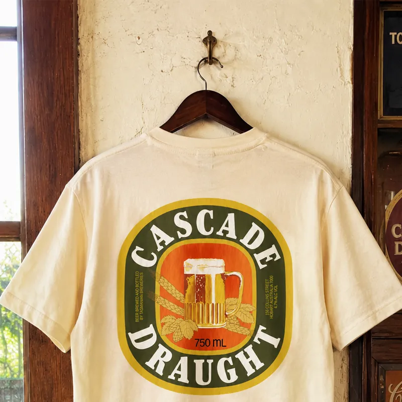 A cream Cascade Draught tee on a hanger