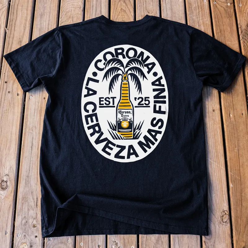 A black Corona tee with a circular print, laid flat