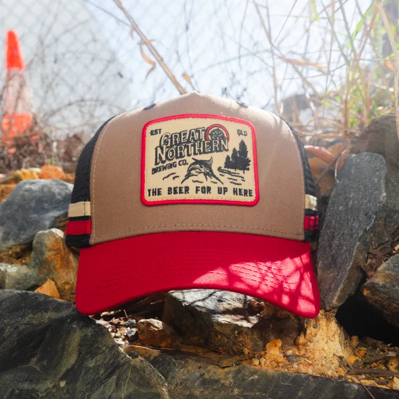A Great Northern trucker cap on the rocks