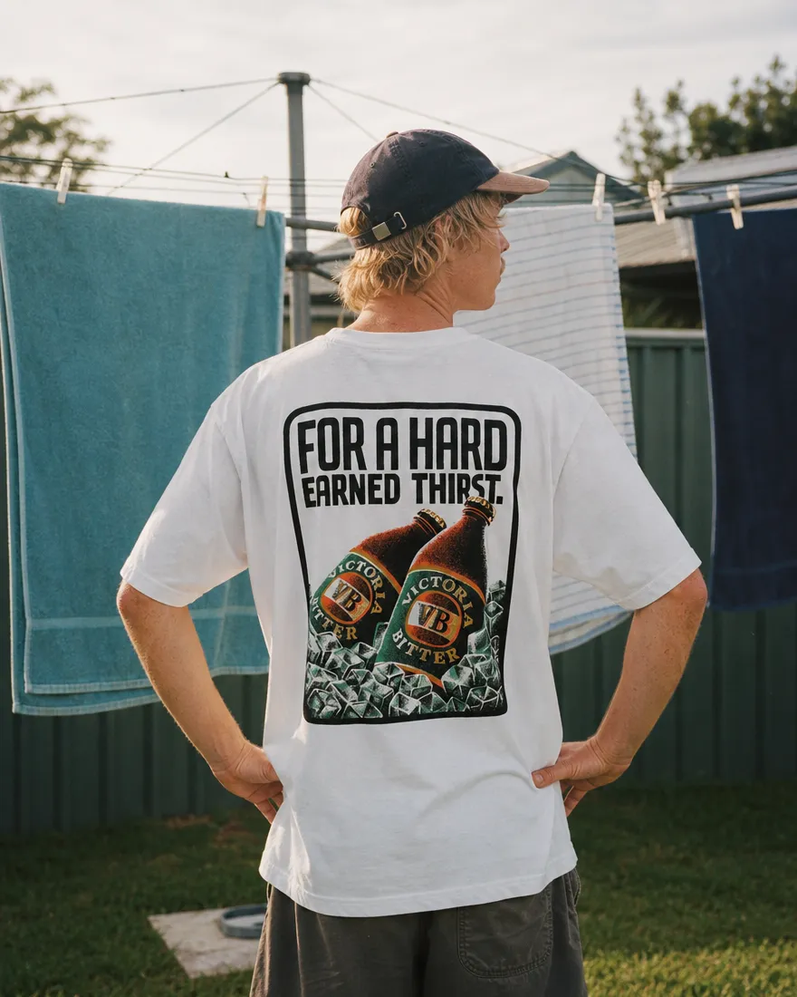 A white tee with a VB back print, worn in front of a Hills Hoist